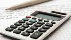 A calculator and a pen and paper.