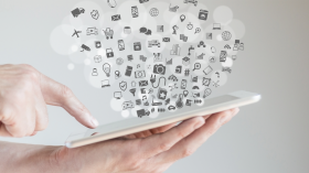 Handheld tablet with icons coming out of the screen