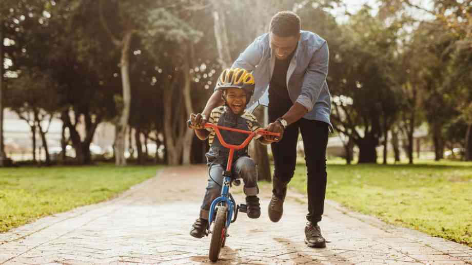 Father teaching his son to ride a bike Father teaching his son to ride a bike