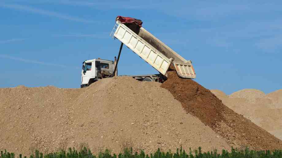 Dump truck depositing soil Dump truck depositing soil