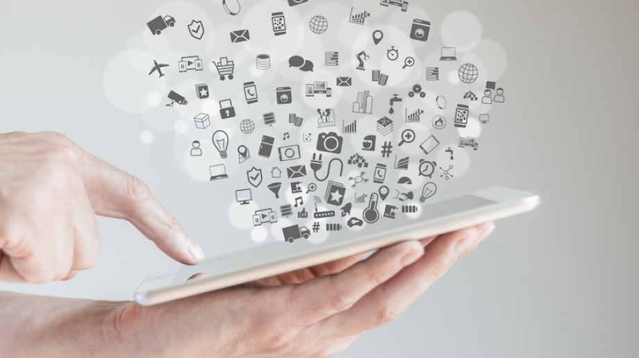 Handheld tablet with icons coming out of the screen