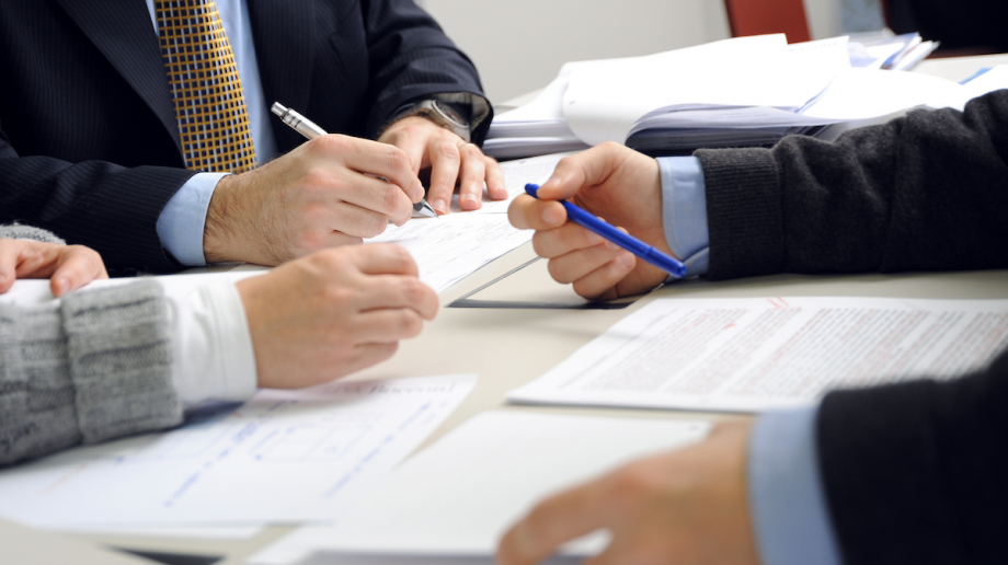 A group of people working together at a desk